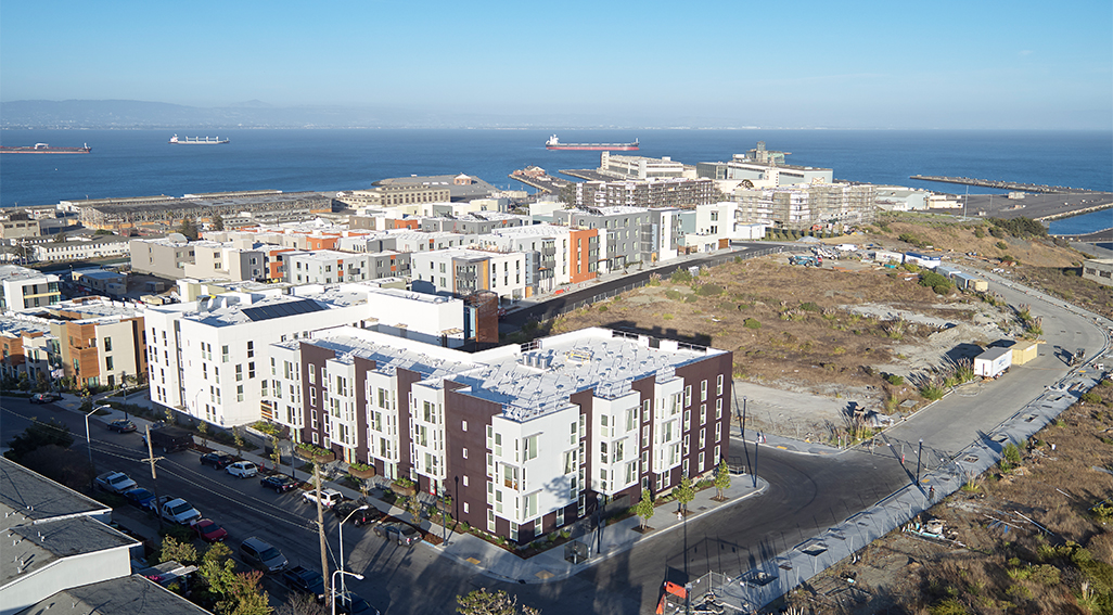 Aerial view of Pacific Pointe apartments with San Francisco bay in background