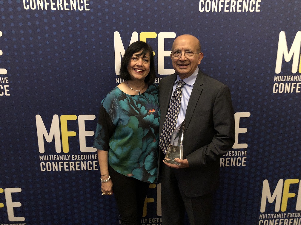 Lux and Percy Vaz at Multifamily Executive Magazine conference holding award
